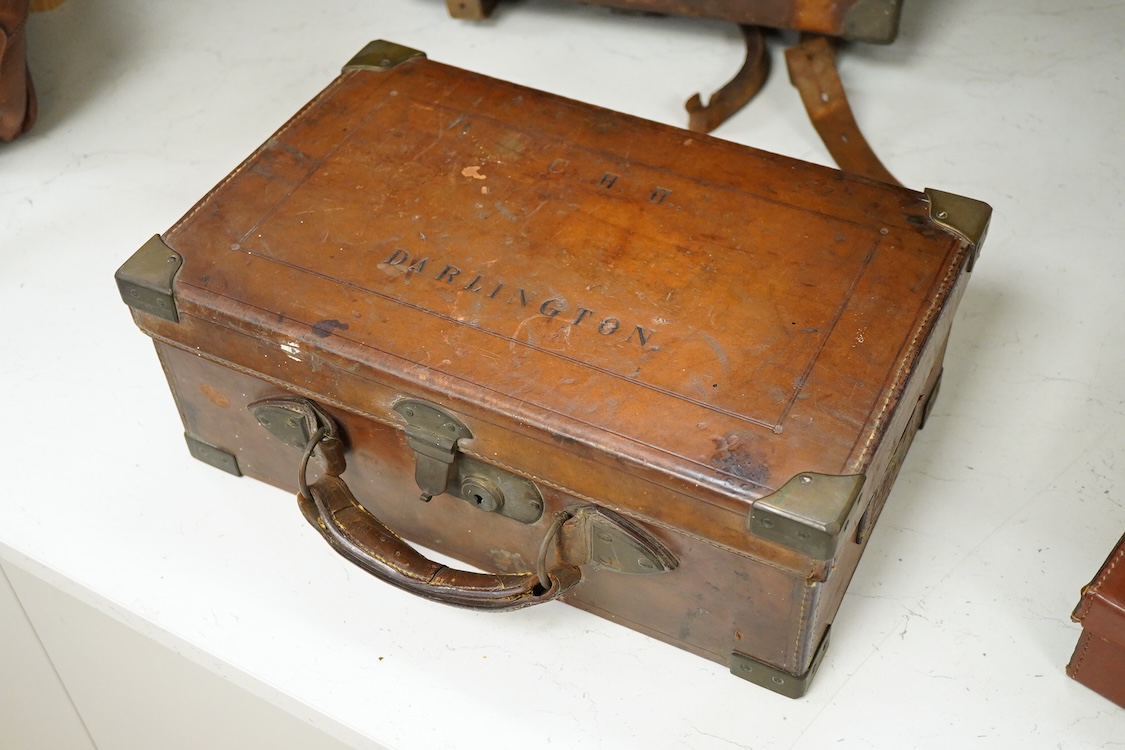 Two late 19th century brown leather magazine cases and another ‘collars’ box, largest 41cm wide